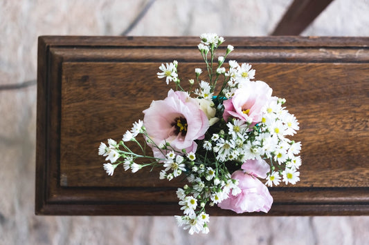 Pink and white flowers symbolizing remembrance, accompanying casket selection guide